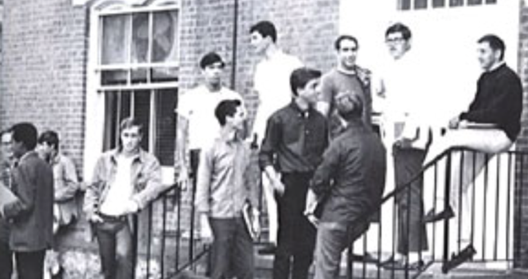 young men hanging out in front of a building