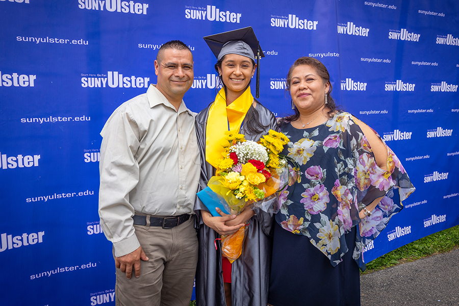 two parents and young woman at graduation