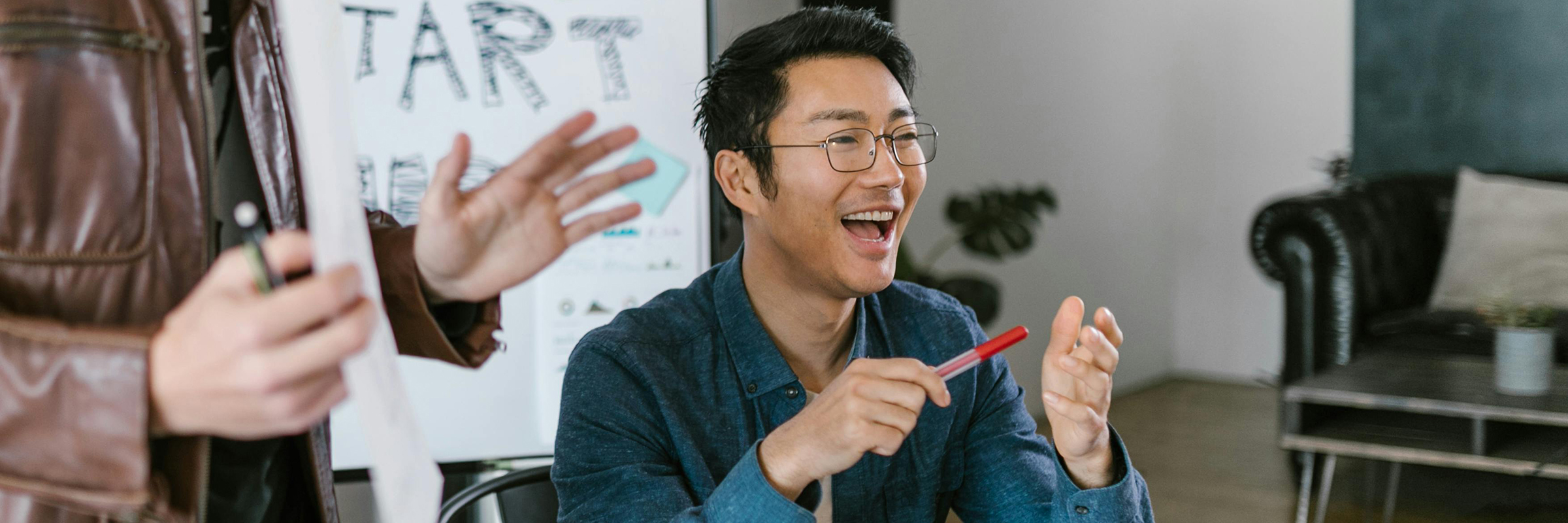 happy business person with glasses, pen, office setting