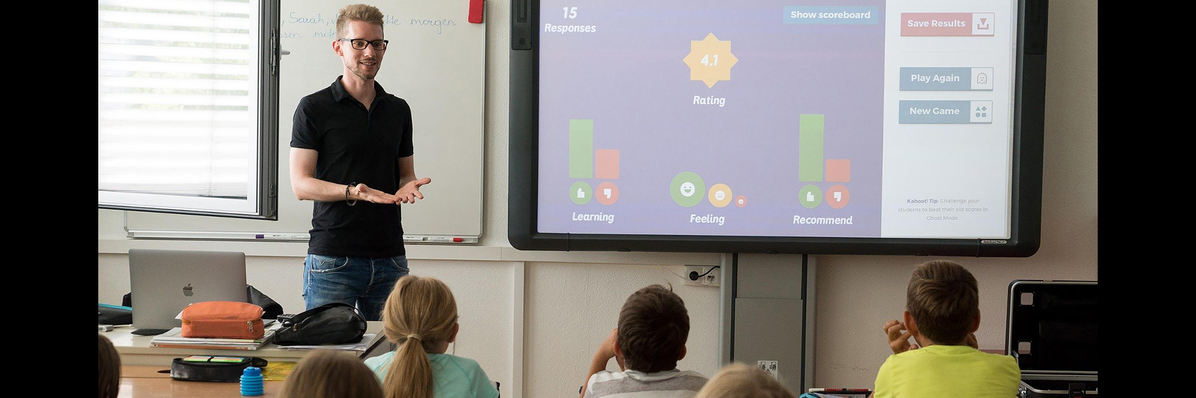 teacher with smartboard and children