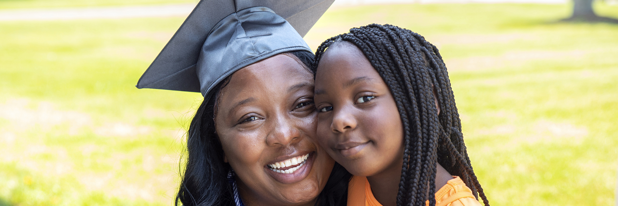 parent in mortarboard with child smiling
